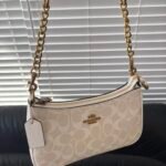Cream Coach shoulder bag with gold chain strap